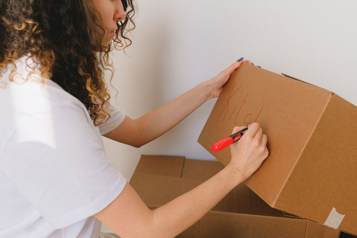 Persona etiquetando cajas para guardarlas en un trastero